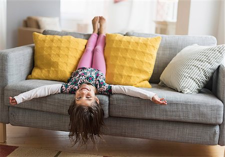 Petite fille qui joue dans un canapé